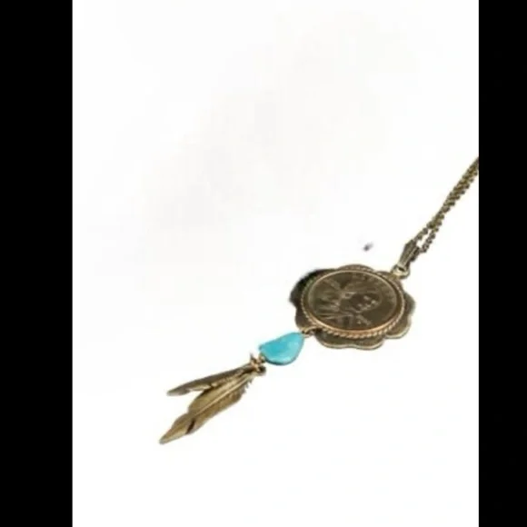 blue turquoise quarter dollar pendant hangs on a 24” gold tone necklace